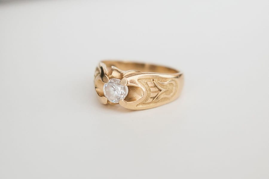 Gold engagement ring on a light background