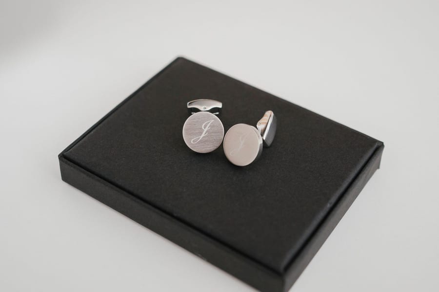 Groom's cufflinks in their box, with his watch and rings