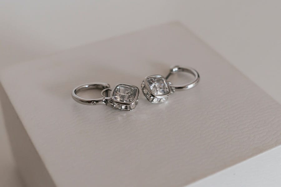 Wedding rings resting on a linen notebook