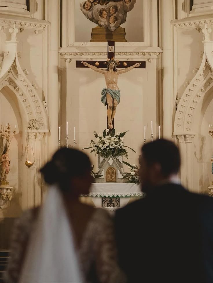 Couple seen from behind at a church altar during the ceremony