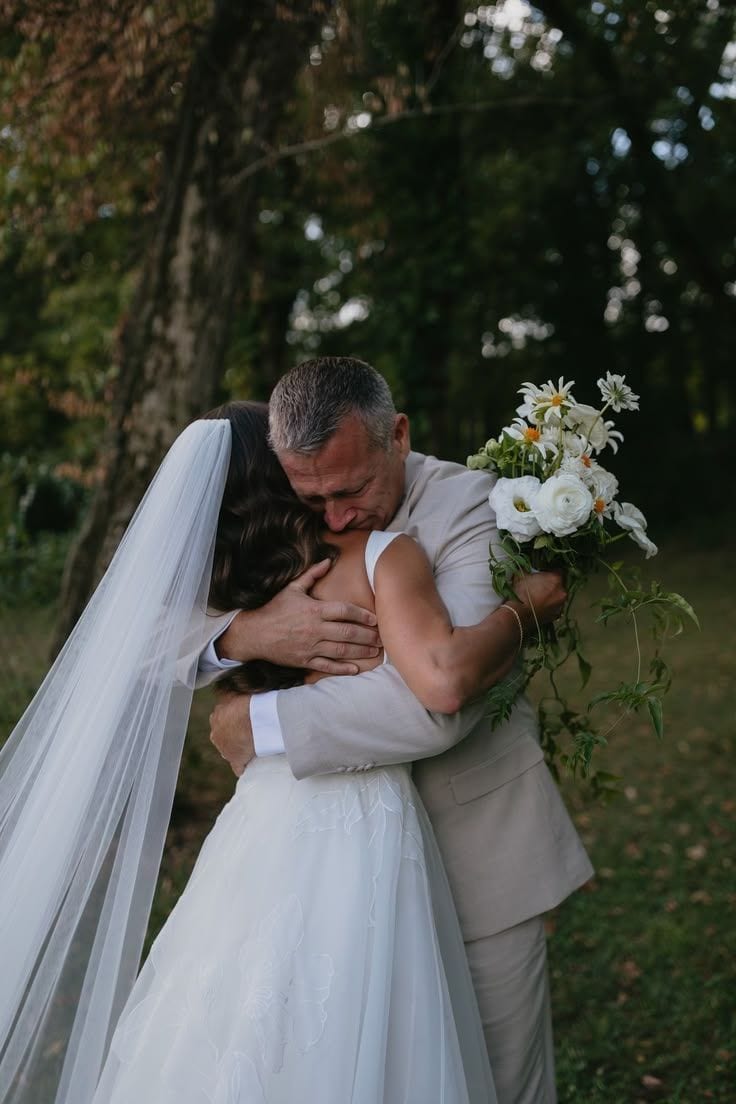 Bride emotionally hugging her father before the ceremony